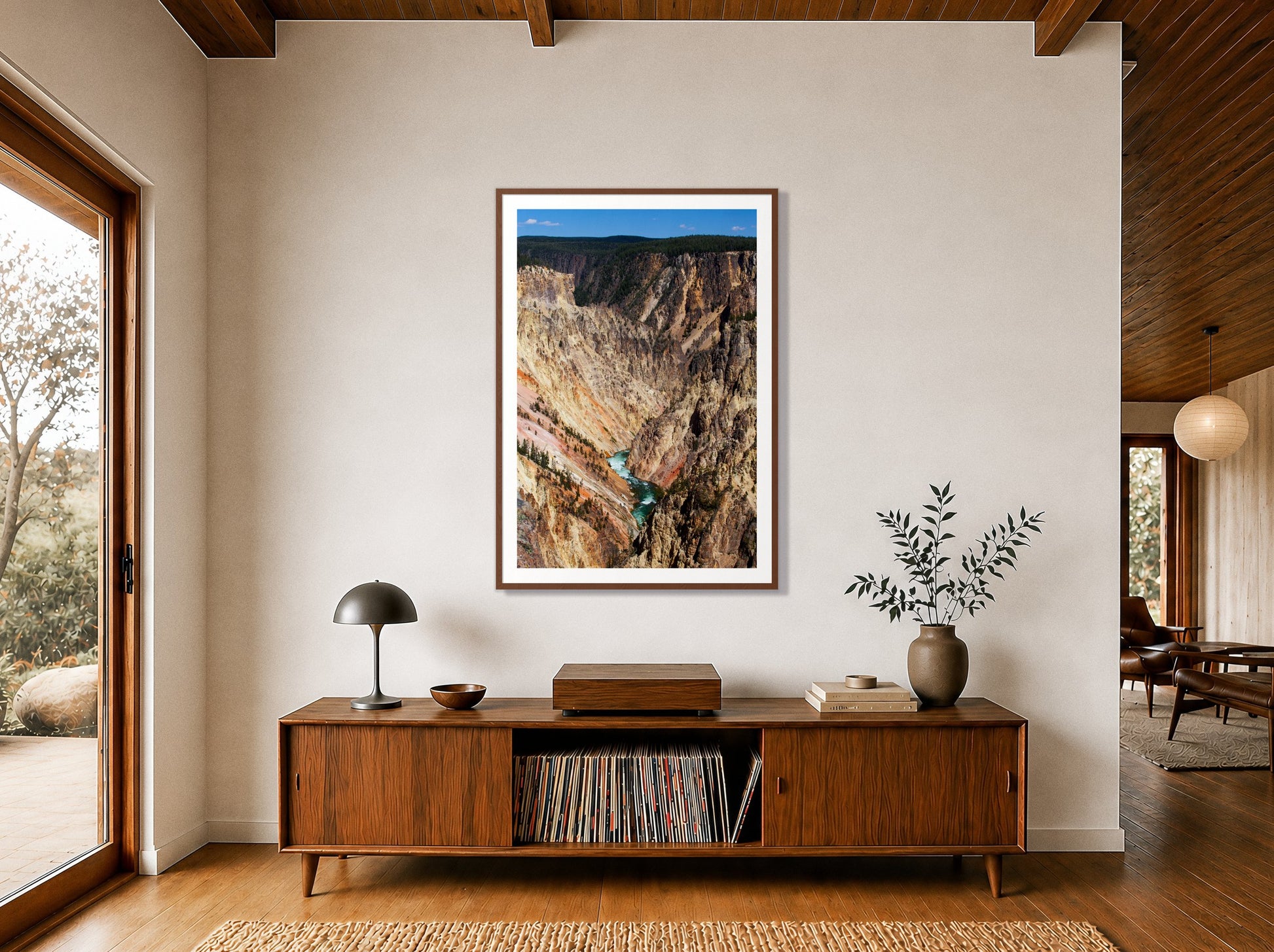 Yellowstone Canyon by Dylan Ozanich in a Walnut frame, above a walnut record credenza in a wood-beamed midcentury room