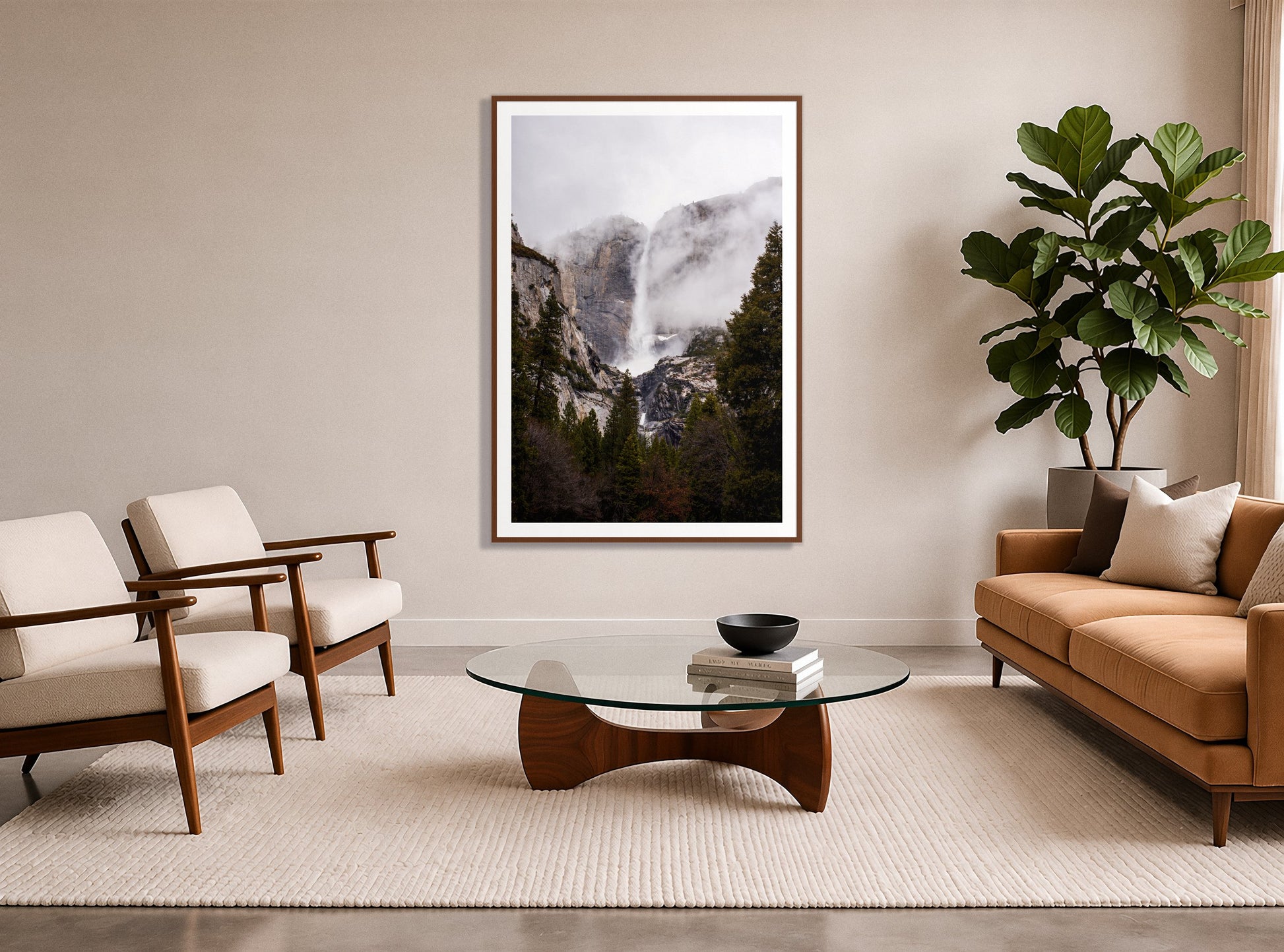 Yosemite Falls by Dylan Ozanich in a Walnut frame, in a midcentury living room with a tan leather sofa and fiddle-leaf fig